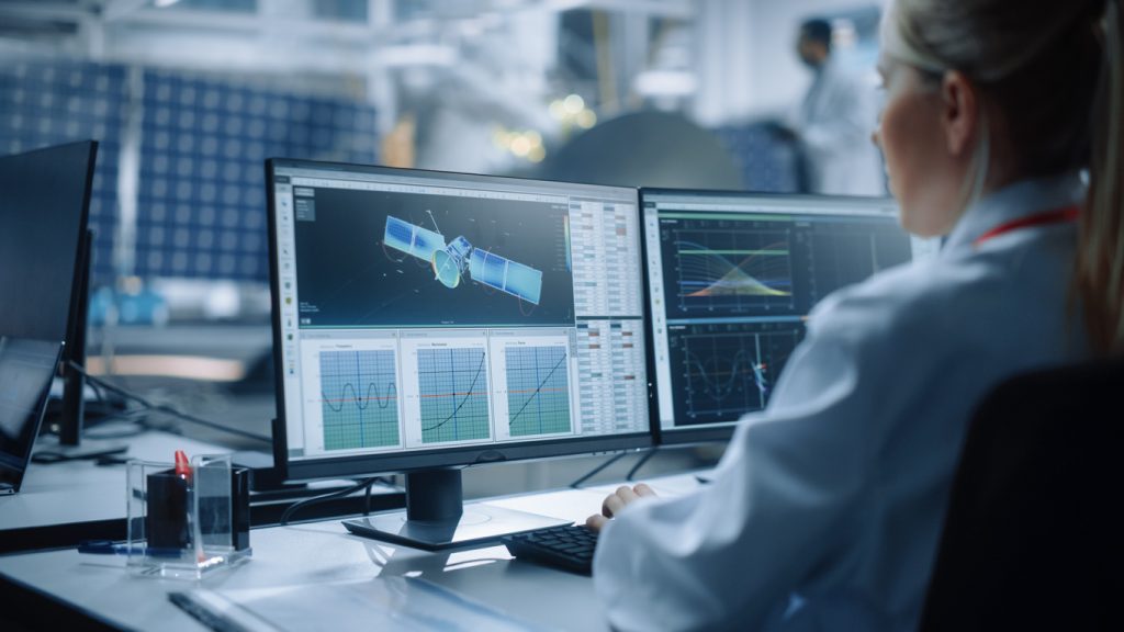 Female Engineer uses Computer to Analyse Satellite, Calculate Orbital Trajectory Tracking. Aerospace Agency International Space Mission: Scientists Working on Spacecraft Construction.